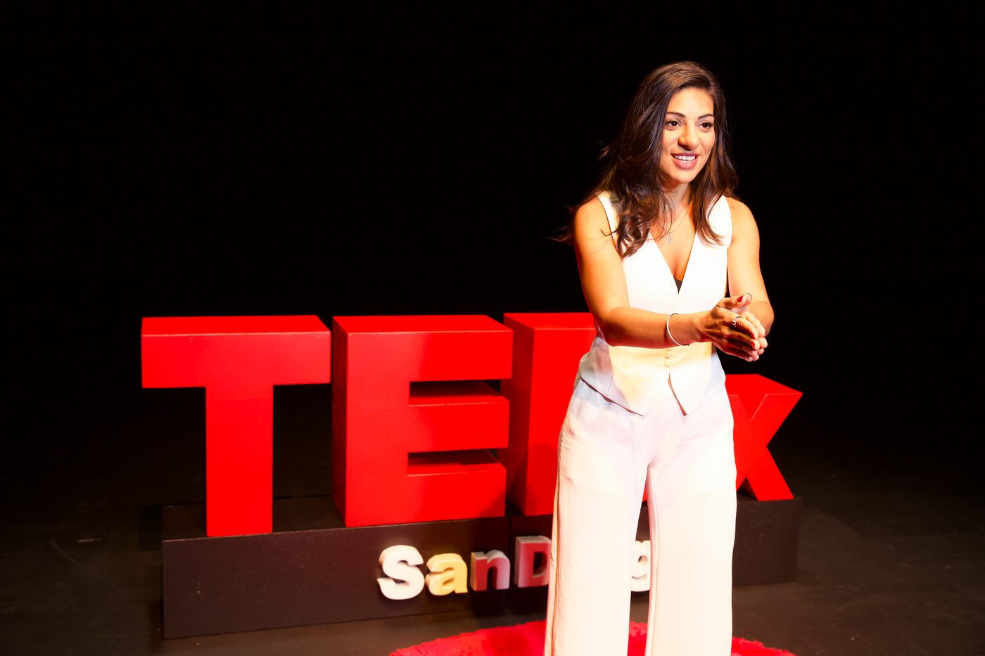 Ari Pereira speaking on the TEDx stage
